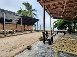 a picnic table and benches on the beach at Guaecá Hostel - Cumuruxatiba in Cumuruxatiba