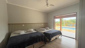 En eller flere senge i et værelse på Sítio Santo Antônio