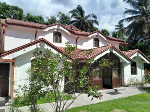a white house with a red roof at Villa Kengalle in Kandy
