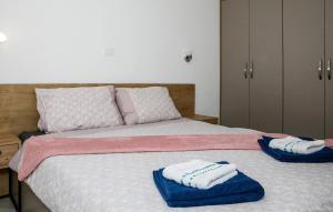 a bedroom with a bed with towels on it at 1 Bedroom Lovely Apartment In Vrsi in Vrsi
