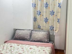a bed with two pillows in a bedroom at Ting Ting Homestay in Hai Phong