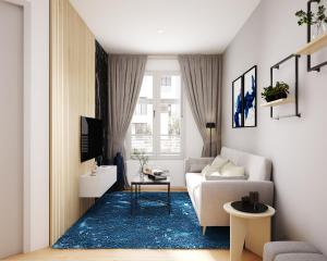 a living room with a couch and a blue rug at Altstadtidyll Neuruppin stilvolle Ferienwohnung im Herzen der Stadt in Neuruppin