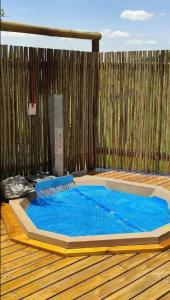 a hot tub in the middle of a wooden floor at Kolobe Luxury Glamping Safari Tent in Fochville +39 photos