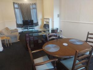 a living room with a wooden table and chairs at Grace House in Stockton-on-Tees