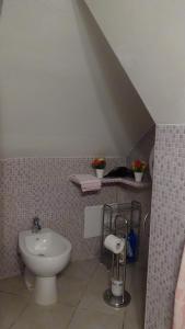 a bathroom with a toilet and a sink at XENIA Vacanze in Gallipoli +8 photos