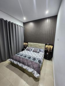 ein Schlafzimmer mit einem Bett und einer schwarzen Wand in der Unterkunft Ajanif Apparte Standing et Fraicheur Salon et Suite Parentale Climatise in Tétouan
