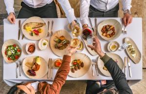 a group of people sitting around a table with food at Zafora Cave Suites Hotel Cappadocia in Uçhisar