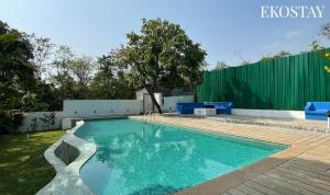 a swimming pool in the backyard of a house at EKO STAY - Solace Villa I Charming Villa close to Candolim Beach in Candolim