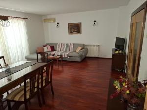 a living room with a couch and a table at Apartman ENA in Opatija