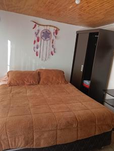 a bedroom with a bed and a cabinet at Habitaciones Pabla in Santiago
