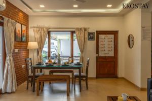 a dining room with a table and chairs at EKO STAY - Solace Villa I Charming Villa close to Candolim Beach in Candolim