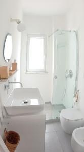 a white bathroom with a sink and a shower at La Pica Marina Anacapri in Anacapri