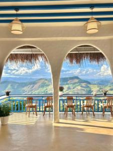 a patio with chairs and a view of the ocean at Nontawa Villa Doichang in Ban Huai Khai