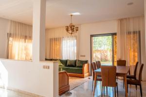 a living room with a table and a couch at Villa Park Marrakech in El Aggada