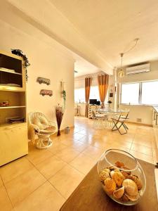 a living room with a bowl of food on a table at T1 na 1 linha da Praia da Rocha in Portimão