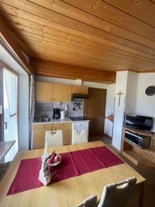 a kitchen with a table with a bowl of fruit on it at Landhaus Laura in Leutasch