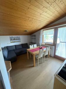 a living room with a table and a couch at Landhaus Laura in Leutasch