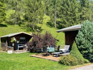 a cabin with a table and chairs in the yard at Landhaus Laura in Leutasch