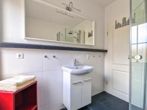 a bathroom with a sink and a mirror at Silbermöwe in Greetsiel +11 photos