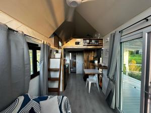 an interior view of a tiny house with a bedroom at Beachfront Tiny House, Koh Samui, Thailand with FREE Rowboat in Nathon Bay
