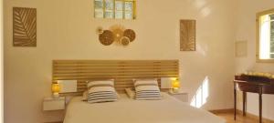 a bedroom with a large bed with two pillows at Prea Gianca in Bonifacio