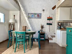 a kitchen and dining room with a table and chairs at La cabane du littoral in La Teste-de-Buch