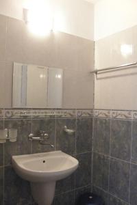 a bathroom with a sink and a mirror at Prestige in Sinemorets