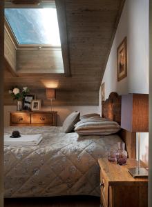 a bedroom with a large bed and a skylight at CGH Résidences & Spas Le Télémark in Tignes