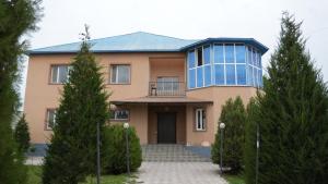 a large house with a balcony on top of it at Hostelhome in Türkistan