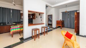 a kitchen and living room with a table and chairs at Caspiro Villa in Habaraduwa