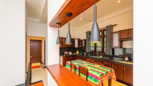 a kitchen with a table in the middle of it at Caspiro Villa in Habaraduwa Central