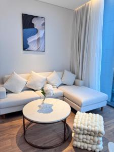 a living room with a couch and a table at SamSet Corner Seaview Studio A La Carte Ha Long Bay in Ha Long