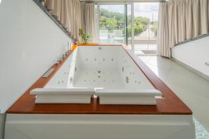 a large bath tub in a room with a table at Agri Suite with jacuzzi - La Bilaia in Lavagna +68 photos