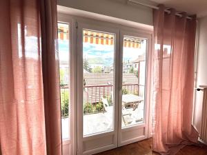 a sliding glass door with a view of a balcony at M057 Joli T3 proche de la frontière in Annemasse