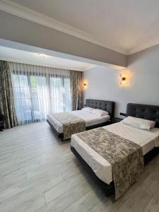 Кровать или кровати в номере Ida Hotel