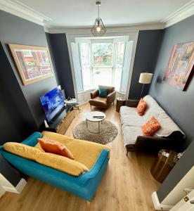 a living room with a couch and a table at Snuze Whitby in Whitby
