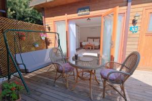 a patio with a table and chairs on a deck at Kabak Avalon Bungalows in Faralya +37 photos