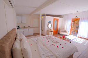a living room with a couch and a table at Kabak Avalon Bungalows in Faralya