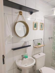 a bathroom with a toilet and a sink and a mirror at House in the Serra de Teresópolis - Chamego da Serra in Teresópolis