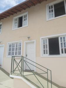 a white house with a staircase in front of it at House in the Serra de Teresópolis - Chamego da Serra in Teresópolis +30 photos