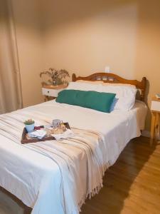 a large white bed with a tray of food on it at House in the Serra de Teresópolis - Chamego da Serra in Teresópolis