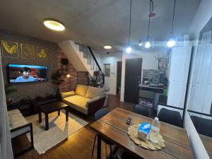 a living room with a couch and a table at Cozy Rustic Corner House Subic in Subic