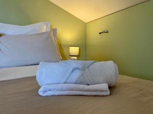 a bed with a pile of towels on it at Studio à Saint-Palais avec parking. in Saint-Palais