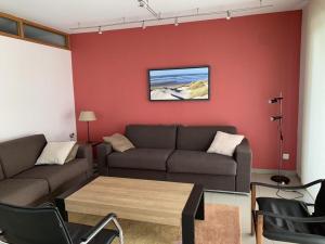 a living room with a couch and a table at Vue Mer, Golfe et Dunes- Résidence Dunes du Golfe in Wimereux +15 photos