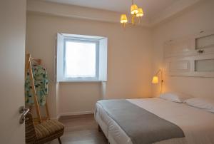 En eller flere senge i et værelse på Vila Marta - Estorninho + 33 billeder