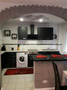 a kitchen with a stove and a washing machine at Apartment Bella Italia in Cologne