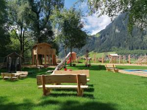 a park with a playground with a slide at Alpenoase Horbergbahn in Schwendau
