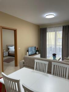 a living room with a couch and a table and chairs at Albanian Bliss in Tirana