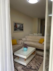 a living room with a couch and a table at Albanian Bliss in Tirana