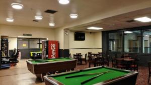 a room with a pool table and some tables and chairs at Faskally Woods Holiday Park in Pitlochry